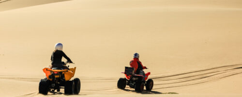 Show full-screen, Quad,Driving,People,-,Two,Happy,Bikers,In,Sand,Desert